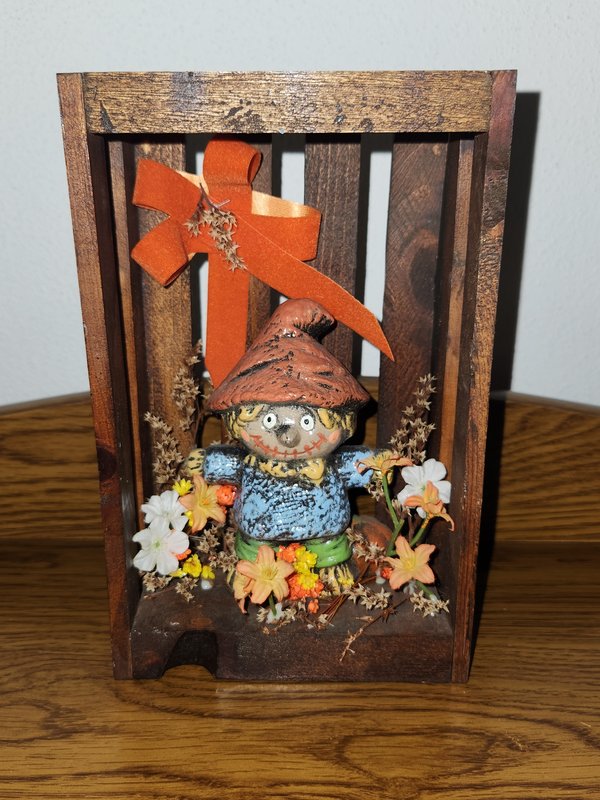 Scarecrow in hanging floral box