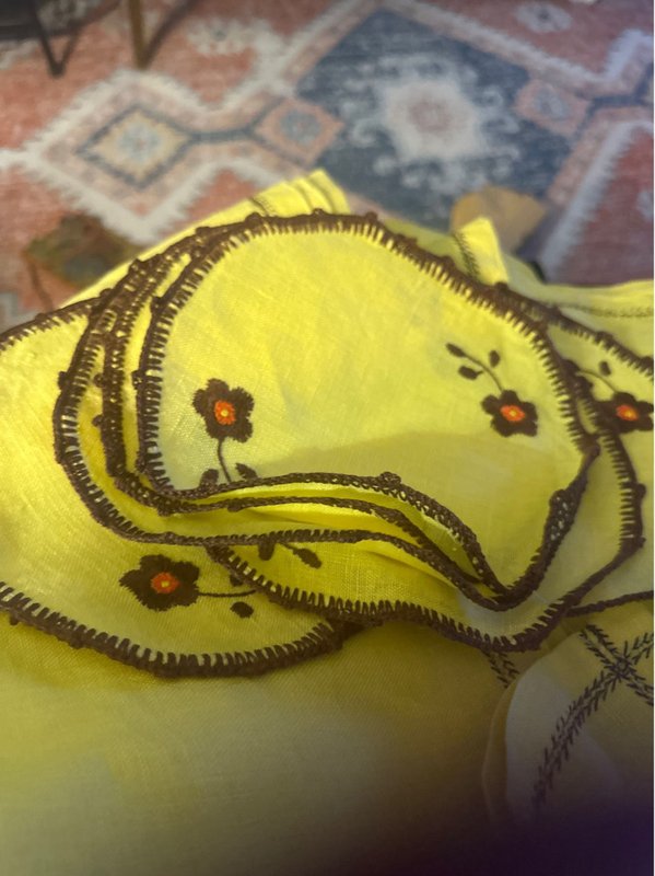 yellow tablecloth with coasters